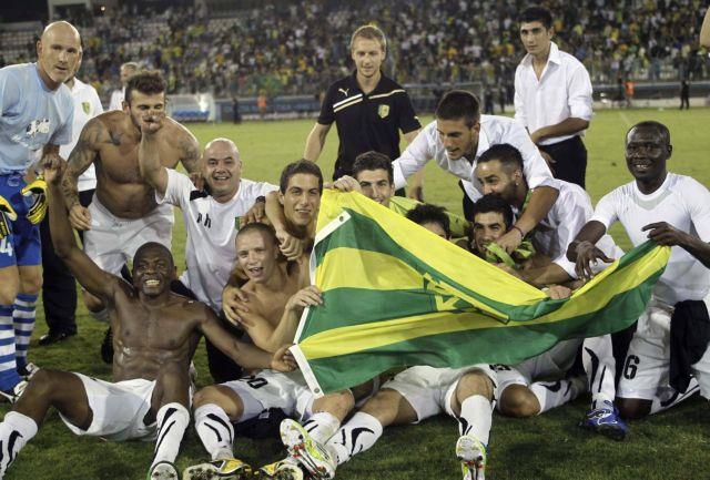 AEK Larnaca players celebrate at the end of their Europa League second leg playoff soccer match against  Rosenborg in Larnaca